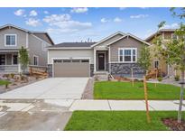 Charming single-Gathering home featuring stone accents, a two-car garage, and a well-manicured lawn at 24747 E 40Th Ave, Aurora, CO 80019