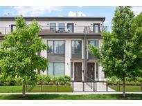 Modern townhome showcasing a landscaped front yard and a private balcony on the upper level at 47 Harrison, Denver, CO 80206
