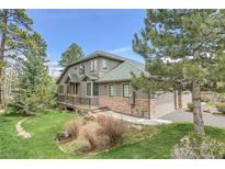 Beautiful home with a stone foundation, attached garage and nicely landscaped yard at 31139 Tahoe Ct, Evergreen, CO 80439