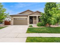 Charming single-Gathering home featuring a two-car garage and a well-manicured lawn, blending comfort and curb appeal at 15061 W 70Th Ave, Arvada, CO 80007