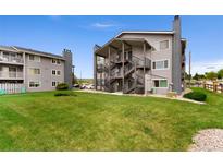 Attractive condo community featuring well-maintained landscaping, external stairs and neutral color palette at 8100 W Quincy Ave # A8, Littleton, CO 80123
