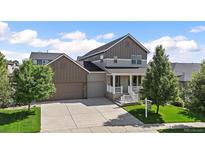 Charming two-story home with two-car garage and welcoming front porch at 4565 Colorado River Dr, Firestone, CO 80504