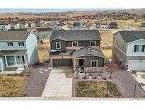 Two-story home boasts attached garage, complemented by xeriscaping and drought-resistant plants in a Gathering-friendly neighborhood at 4807 River Highlands Loop, Elizabeth, CO 80107