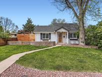Charming single-story home featuring a well-manicured front yard, brick accents, and inviting walkway at 4747 S Elati St, Englewood, CO 80110