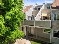 Inviting townhome featuring neutral siding, a private entrance, and a cozy covered porch at 2678 S Xanadu Way # C, Aurora, CO 80014