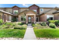 Charming townhome with brick accents, well-maintained landscaping, and inviting front entrance at 6418 Silver Mesa Dr # C, Highlands Ranch, CO 80130