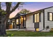 Charming home with stone accents, a well-maintained lawn, and appealing curb appeal at 6369 W 69Th Ave, Arvada, CO 80003