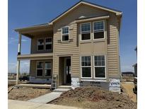 Charming two-story home featuring large windows, a covered porch, and ample natural light; ready for personalization at 24207 E 53Rd Dr, Aurora, CO 80019