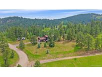 Beautiful mountain home situated on a large lot surrounded by lush trees at 9745 Hilldale Dr, Morrison, CO 80465