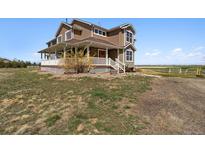 Charming two-story home featuring a covered front porch and situated on a spacious lot at 1212 N County Road 125, Bennett, CO 80102