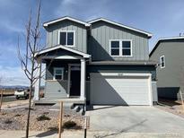 Charming two-story home boasts modern architecture with a two-car garage and well-maintained landscaping at 2237 Flower Blossom Ave, Brighton, CO 80601