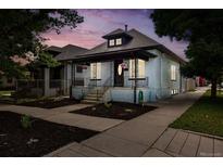 Charming home with a welcoming front porch and beautifully landscaped yard at 4059 Quivas St, Denver, CO 80211