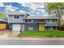 Charming two-story home with a well-manicured front yard and a two car garage at 8506 Eaton St, Arvada, CO 80003