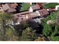 A sprawling property with a main house, carriage house, mature trees, and a private backyard space at 4500 Zephyr St, Wheat Ridge, CO 80033