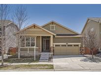 Charming single-Gathering home featuring a manicured front yard and an attached two-car garage at 14952 Vienna Cir, Parker, CO 80134