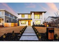 Contemporary two-story home boasts a sleek design and manicured front yard, enhancing curb appeal at 1518 S Columbine St, Denver, CO 80210