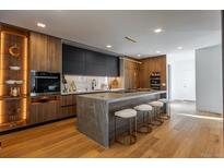 Modern kitchen with wood cabinetry, marble countertops, and a large island at 1518 S Columbine St, Denver, CO 80210