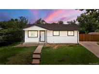 Charming single-story home boasts a well-manicured lawn and freshly painted exterior at 871 S Worchester St, Aurora, CO 80012