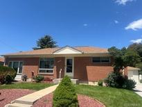 Charming brick ranch-style home with well-maintained landscaping and a cozy front porch at 10759 Ogden St, Northglenn, CO 80233