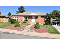 Charming brick home featuring manicured landscaping and a welcoming front entrance at 10759 Ogden St, Northglenn, CO 80233