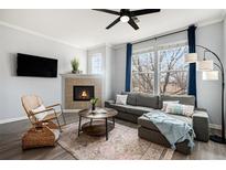 Cozy living room featuring a fireplace, comfortable seating, and large windows at 12844 King St, Broomfield, CO 80020