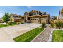 Beautiful two-story home featuring a three-car garage and a well-maintained lawn at 16321 Clayton St, Thornton, CO 80602