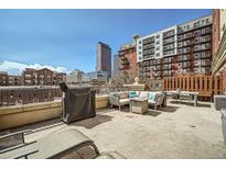 Expansive rooftop deck with grill, seating and views of the downtown skyline provides great entertaining space at 1950 N Logan St # 411, Denver, CO 80203