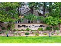 Community entrance sign surrounded by mature trees and manicured landscaping at 4545 S Monaco St, Denver, CO 80237