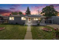 Charming single-story home with solar panels and well-maintained front yard at dusk at 7350 Dale Ct, Westminster, CO 80030
