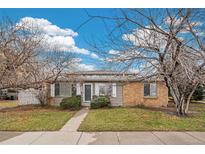 Charming single-story home with a brick and siding facade, complemented by a well-manicured lawn at 1336 Sable Blvd, Aurora, CO 80011