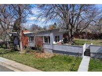 Stunning exterior view of home, with a modern design and mature trees, nestled in a quiet neighborhood at 1400 E Bates Ave, Englewood, CO 80113