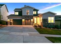 Beautiful two-story home with stone accents, a wide driveway, and a spacious two-car garage at 14337 Shasta Daisy Pt, Parker, CO 80134