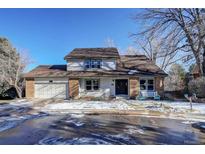 Two-story home with brick and siding, attached garage, and landscaping at 3080 E Geddes Pl, Centennial, CO 80122