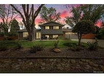 Charming two-story home featuring mature landscaping and a well-manicured front yard at 11305 W 78Th Dr, Arvada, CO 80005
