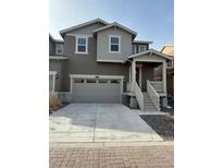 Charming two-story home featuring a covered entry, attached garage, and neutral-toned exterior at 9041 Redfield Ln, Parker, CO 80134