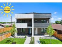 Modern two-story duplex featuring unique black and white facade, manicured front yard, and available incentives at 1953 W 47Th Ave, Denver, CO 80211