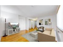 Bright living room with hardwood floors and large windows at 1056 N Marion St # 204, Denver, CO 80218