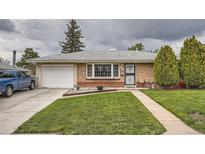 Charming brick home with a well-manicured lawn, attached garage, and inviting front entrance at 3751 W 85Th Ave, Westminster, CO 80031