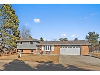 Charming brick home with a well-manicured front yard and an attached two-car garage at 7110 S Cherry Dr, Centennial, CO 80122