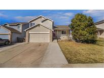 Charming two-story home featuring a two-car garage, well-maintained lawn, and a welcoming front porch at 465 S 24Th Ave, Brighton, CO 80601