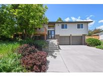 Inviting two-story home with a charming front yard, beautiful landscaping and a two-car garage at 1073 Xenon St, Golden, CO 80401