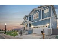Charming two-story home boasting an attached garage, well-manicured lawn, and inviting front porch at 900 Eldorado Ln, Louisville, CO 80027