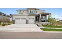Charming two-story home with a three-car garage, well-maintained lawn, and inviting porch at 23814 E 36Th Pl, Aurora, CO 80019