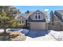 Charming two-story home with well-manicured lawn, two-car garage, and classic architectural details at 5421 E Prescott Ave, Castle Rock, CO 80104