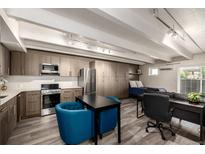 Inviting living space featuring a modern kitchen, dining area, and comfortable seating in a naturally lit open floor plan at 1495 Vrain St # 110, Denver, CO 80204