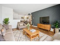 Bright living room with wood floors, stylish furniture, and a view to dining area at 5102 Williams Fork Trl # 109, Boulder, CO 80301