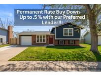 Charming two-story home featuring a well-manicured lawn, brick accents, and a vibrant red front door at 4512 S Yank St, Morrison, CO 80465