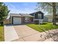 Charming two-story home with attached garage, brick accents and manicured front lawn at 4512 S Yank St, Morrison, CO 80465