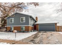 Charming two-story home featuring a brick facade and a well-maintained yard, complete with an attached two-car garage at 6280 S Colorado Blvd, Centennial, CO 80121