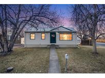 Cute ranch home with a well-maintained lawn and walkway at 401 S Oak St, Lakewood, CO 80226